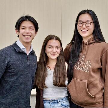 Three students smiling