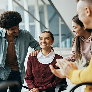 Woman surrounded by encouraging friends