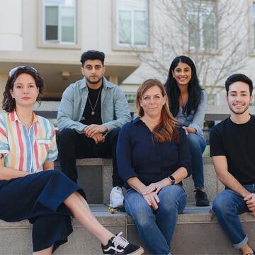 Students sitting and posing outside