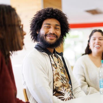 Student smiling and chatting with peers