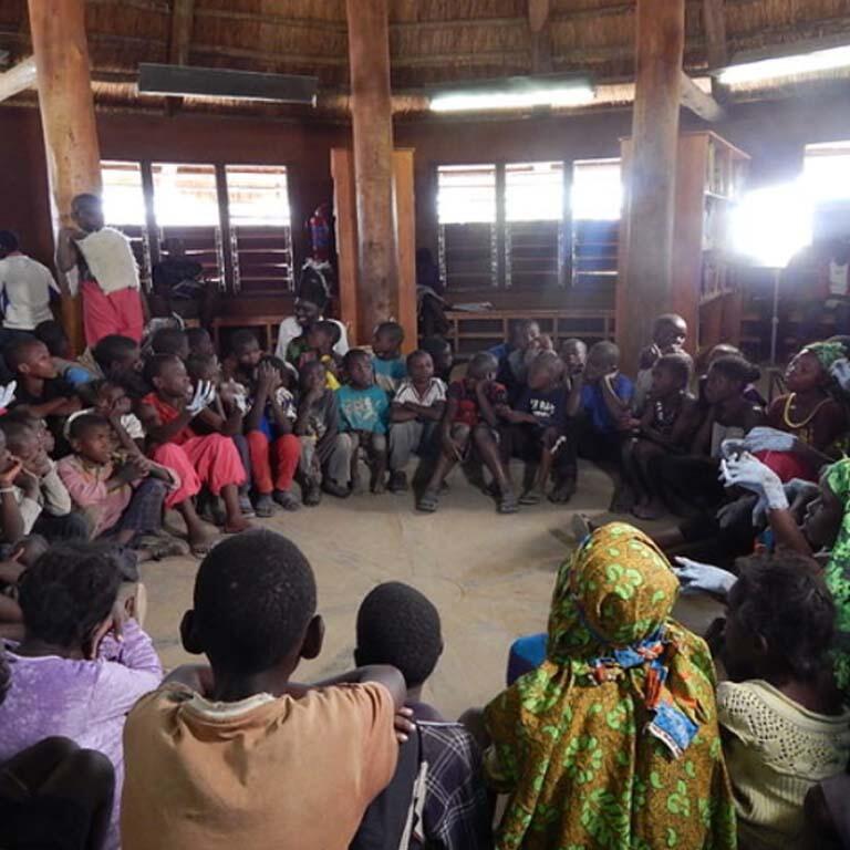 A group gather in a circle inside the Lubuto Library in Zambia