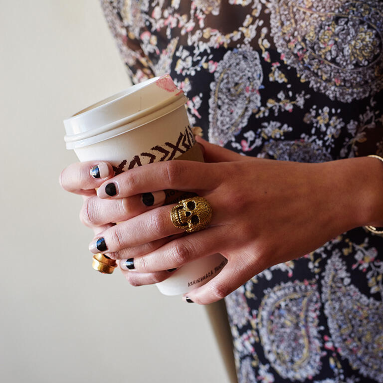 holding coffee cup