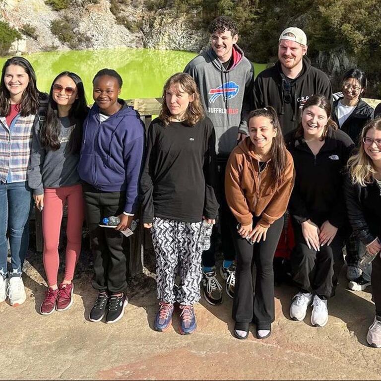 Students in front of a pond in New Zealand