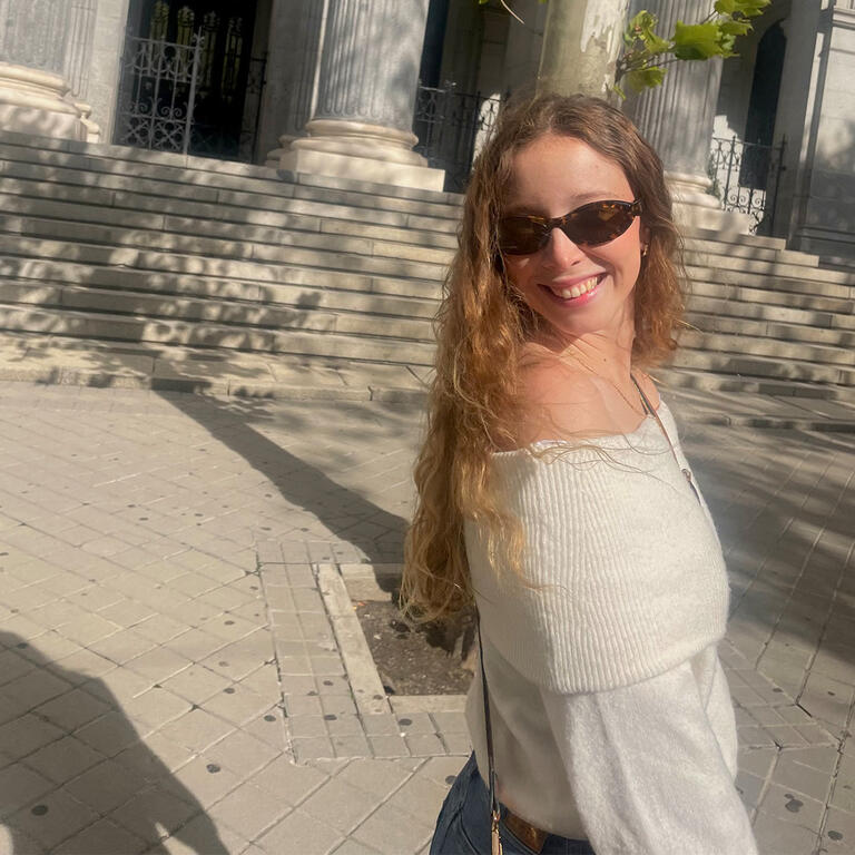 Student walks near marble building in Spain