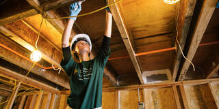 Student volunteering building a house