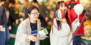 Two students enjoy shooting hoops at hilltop campus carnival.