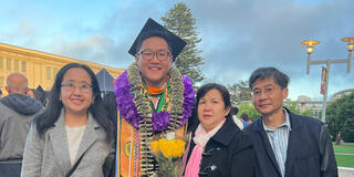 norman feng standing with his family during graduation