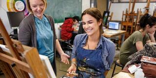 A student and teacher in art class