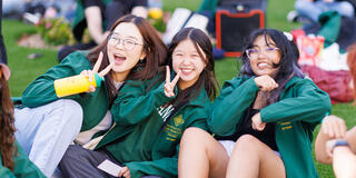 students giving a peace sign