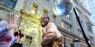 Person dancing under disco ball.