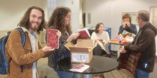 Four leaf student holding a book