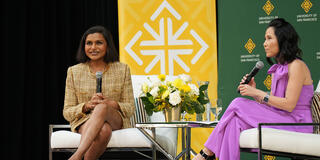 Mindy Kaling sitting next to Vicky Nguyen on stage