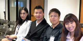 Four student sit and pose for picture