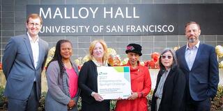 School of Management Dean Elizabeth Davis (center, left) and associate professor Monika Hudson (center, right) show their pride in USF’s recognition. 