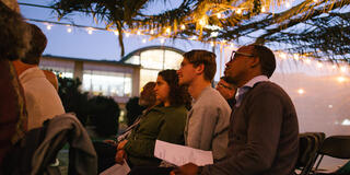 People gathered under the sukkah in the evening