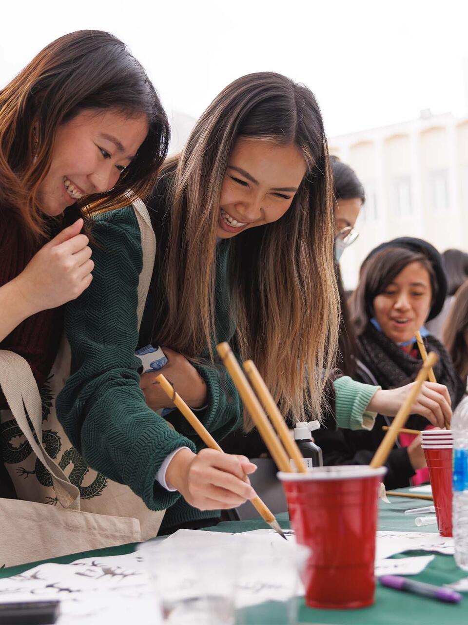 Students painting at a table